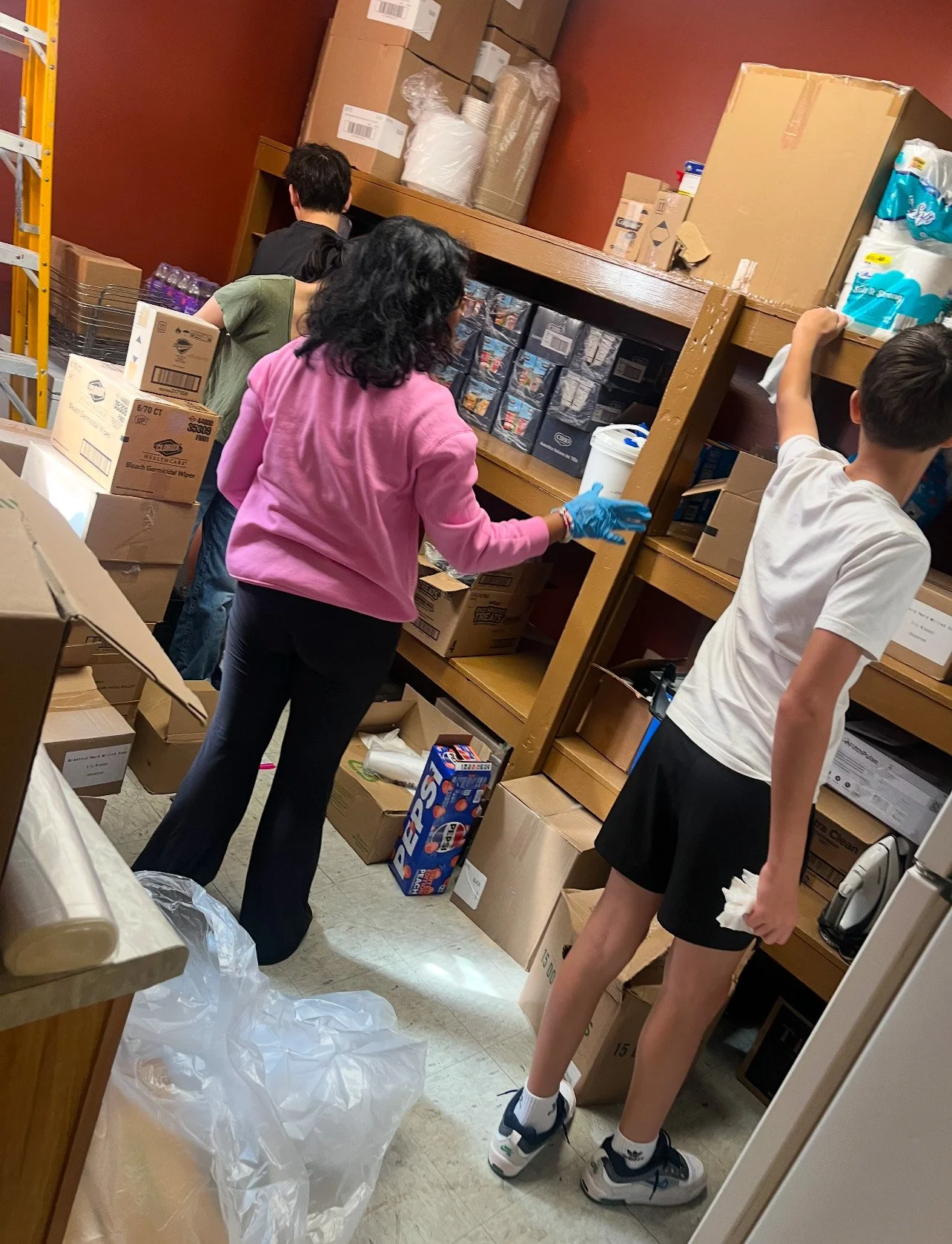 Volunteers stocking shelves with donated food and supplies