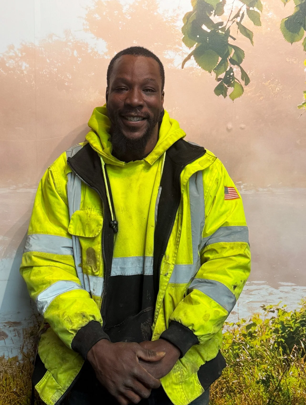 Christopher M. Goff smiling outdoors in a high-visibility work jacket