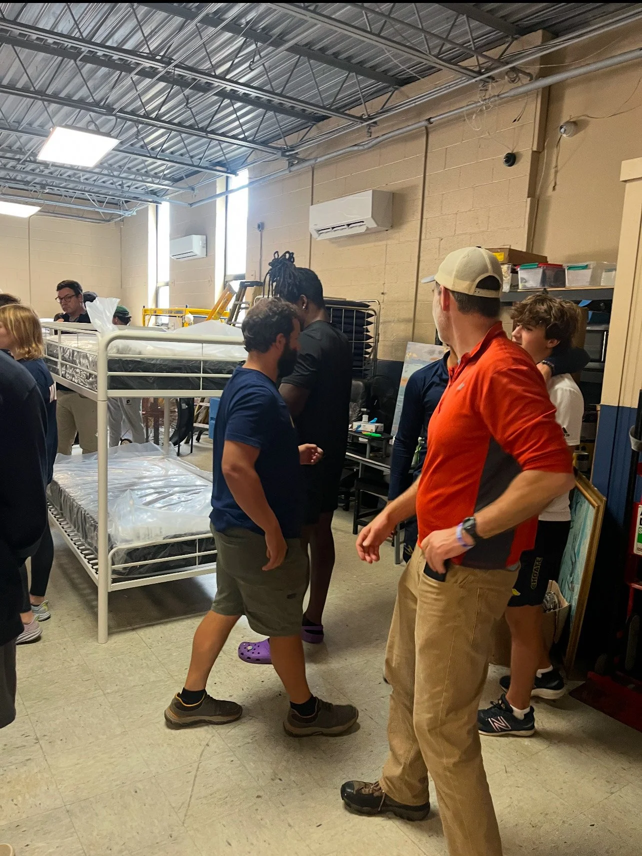 Volunteers assembling bunk beds in the shelter dormitory